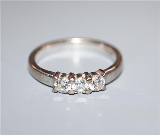 A modern 18ct white gold and three stone diamond ring, size N.